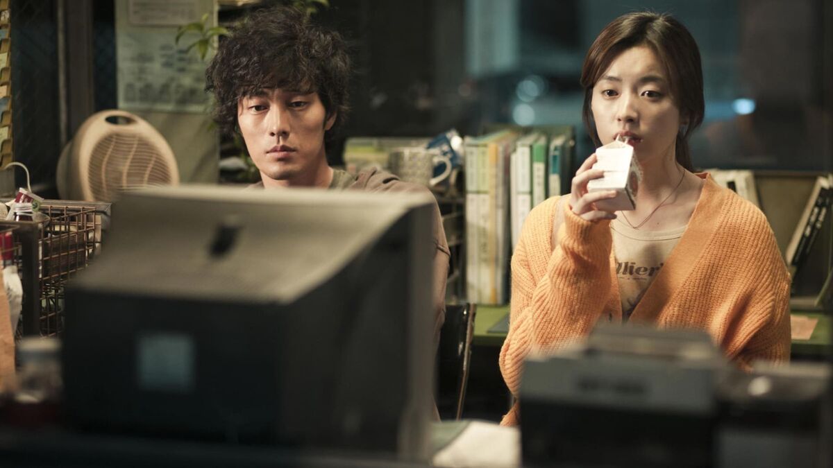 A man and woman are watching tv in a still from Always