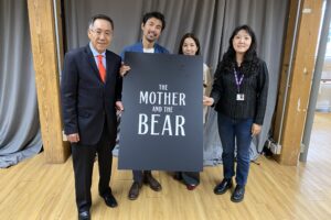 Lee Won-jae, Johnny Ma, Kim Ho-jung, and Grace Han pose with a poster of "The Mother and the Bear"
