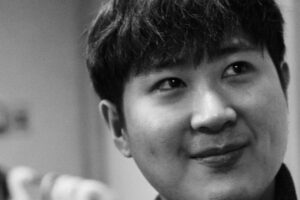 A grayscale headshot of Jerome Yoo.